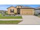 Charming single-Gathering home featuring a well-manicured lawn and a two-car garage at 313 Old Windsor Way, Spring Hill, FL 34609