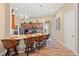 Stylish kitchen features a breakfast bar, pendant lighting, stainless steel appliances, and modern finishes at 313 Old Windsor Way, Spring Hill, FL 34609