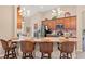 Stylish kitchen with granite countertops, mosaic backsplash, and breakfast bar seating at 313 Old Windsor Way, Spring Hill, FL 34609