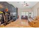 Living room features hardwood floors, a ceiling fan, and comfortable seating at 313 Old Windsor Way, Spring Hill, FL 34609