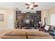 Cozy living room featuring a wood accent wall, ceiling fan, and comfortable seating at 313 Old Windsor Way, Spring Hill, FL 34609