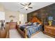 Spacious main bedroom features a decorative wood wall, elegant furnishings, and ample natural light at 313 Old Windsor Way, Spring Hill, FL 34609