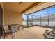 Screened patio with ceiling fan, tile floors, and patio seating at 313 Old Windsor Way, Spring Hill, FL 34609