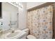 Bathroom with a classic vanity, toilet, and a shower with decorative shower curtain at 3350 Mermoor Dr # 1201, Palm Harbor, FL 34685