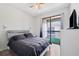 Inviting bedroom featuring a comfortable bed and sliding doors that lead to a private balcony at 3350 Mermoor Dr # 1201, Palm Harbor, FL 34685