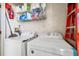 Bright laundry room including a washer, dryer and shelving at 3350 Mermoor Dr # 1201, Palm Harbor, FL 34685