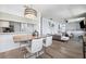 Open-concept living space with modern dining area adjacent to a comfortable living room at 3350 Mermoor Dr # 1201, Palm Harbor, FL 34685