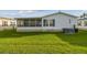 This home features a cozy screened in porch with a lush green backyard, perfect for relaxing or entertaining at 37545 Lilly Bea Ave, Zephyrhills, FL 33541
