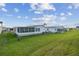 Exterior view of a home with a large manicured backyard at 37545 Lilly Bea Ave, Zephyrhills, FL 33541