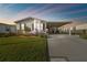 Charming single-story home features a well-manicured lawn, carport, and vibrant landscaping with colorful flowers at 37545 Lilly Bea Ave, Zephyrhills, FL 33541