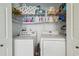 Laundry area with side-by-side washer and dryer, shelves, and storage space at 37545 Lilly Bea Ave, Zephyrhills, FL 33541