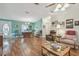 Bright living room features wood floors, a ceiling fan, and comfortable seating, creating a welcoming space at 37545 Lilly Bea Ave, Zephyrhills, FL 33541