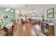 Open-concept living area with wood floors provides a seamless flow for entertaining and relaxation at 37545 Lilly Bea Ave, Zephyrhills, FL 33541