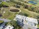 Aerial view of condo community on golf course with pond and covered parking at 3829 Trophy Blvd, New Port Richey, FL 34655