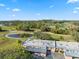 Aerial view of community with mature trees, golf course, and serene pond at 3829 Trophy Blvd, New Port Richey, FL 34655