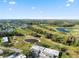 Aerial shot of a golf community featuring lush greenery, water features, and residential buildings at 3829 Trophy Blvd, New Port Richey, FL 34655