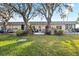 Charming backyard with patio seating and lush landscaping at 3829 Trophy Blvd, New Port Richey, FL 34655