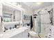 A stylish bathroom featuring marble walls, a glass-enclosed shower, and modern fixtures at 3829 Trophy Blvd, New Port Richey, FL 34655