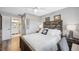 Comfortable bedroom features a ceiling fan, wood-look floors, and a view into the bright, clean ensuite bathroom at 3829 Trophy Blvd, New Port Richey, FL 34655