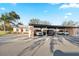 Charming home featuring a convenient carport with multiple parking spaces and mature landscaping at 3829 Trophy Blvd, New Port Richey, FL 34655