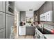 A modern kitchen with gray cabinets, white countertops, and stainless-steel appliances offers a stylish cooking space at 3829 Trophy Blvd, New Port Richey, FL 34655