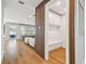 Hallway featuring hardwood floors, bench with coat hooks, and a partial view of living spaces at 4012 W Morrison Ave, Tampa, FL 33629