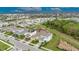 An aerial view of a single Gathering home set amongst community, ponds, and beautiful scenery at 407 Sandsend Ct, Apollo Beach, FL 33572