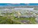 A stunning aerial view of a single Gathering home, nearby lake, and the surrounding neighborhood at 407 Sandsend Ct, Apollo Beach, FL 33572