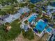 Upscale community featuring a sprawling pool area, lounge chairs and palm trees at 407 Sandsend Ct, Apollo Beach, FL 33572