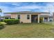 Well-maintained backyard with green lawn, manicured shrubs, and a view of neighboring properties at 407 Sandsend Ct, Apollo Beach, FL 33572