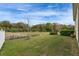 Expansive backyard featuring a green lawn, mature trees, and serene natural views at 407 Sandsend Ct, Apollo Beach, FL 33572