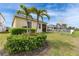 Lush backyard with palm trees, privacy landscaping, and a screened patio for outdoor enjoyment at 407 Sandsend Ct, Apollo Beach, FL 33572
