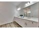 Modern bathroom featuring double sink vanity and walk-in shower at 407 Sandsend Ct, Apollo Beach, FL 33572