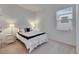 Cozy bedroom with a large window letting in natural light, with carpet flooring, and a side table at 407 Sandsend Ct, Apollo Beach, FL 33572