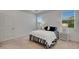 Bright bedroom features natural light and neutral colored carpet at 407 Sandsend Ct, Apollo Beach, FL 33572