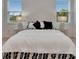Bright bedroom with two windows and stylish bedside lamps at 407 Sandsend Ct, Apollo Beach, FL 33572