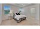 Bedroom with a walk-in closet, and two windows, each with white lamps on side tables at 407 Sandsend Ct, Apollo Beach, FL 33572