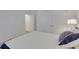 Close-up of a bed with pillows, a side table, and double doors leading to another room at 407 Sandsend Ct, Apollo Beach, FL 33572