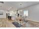 A bright dining area flows into a kitchen with an island and stainless steel appliances at 407 Sandsend Ct, Apollo Beach, FL 33572