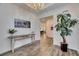 Elegant entryway featuring beautiful flooring, a rustic console table, and stylish decor at 407 Sandsend Ct, Apollo Beach, FL 33572