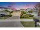 Beautiful single-Gathering home featuring lush landscaping, a brick driveway, and a two-car garage at 407 Sandsend Ct, Apollo Beach, FL 33572