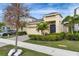 Inviting single-Gathering home with lush landscaping, a brick driveway, and a two-car garage at 407 Sandsend Ct, Apollo Beach, FL 33572