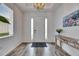 Bright and airy foyer featuring stylish flooring, modern lighting, and elegant decor at 407 Sandsend Ct, Apollo Beach, FL 33572