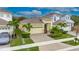 Beautiful single-Gathering home boasting manicured landscaping, palm trees, and a brick-paved driveway at 407 Sandsend Ct, Apollo Beach, FL 33572