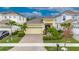 Inviting single-Gathering home featuring a 2-car garage, attractive landscaping, and a brick-paved driveway at 407 Sandsend Ct, Apollo Beach, FL 33572