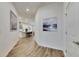 Hallway view showcasing sleek flooring, recessed lighting, and an open view to the kitchen at 407 Sandsend Ct, Apollo Beach, FL 33572