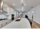 Bright kitchen with a large island, stainless steel appliances, and a seamless view into the living area at 407 Sandsend Ct, Apollo Beach, FL 33572