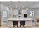 Bright kitchen with stainless steel appliances, pendant lights, island seating, and a gas range at 407 Sandsend Ct, Apollo Beach, FL 33572