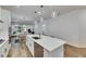 Kitchen island with a quartz countertop, stainless steel dishwasher, and a view of the dining and living areas at 407 Sandsend Ct, Apollo Beach, FL 33572