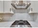 A modern gas range with stainless steel hood at 407 Sandsend Ct, Apollo Beach, FL 33572